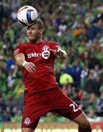 Seattle's Clint Dempsey (2) is held back by Toronto's Eriq Zavaleta (15) as Josh Williams (23) heads the ball during the second half of the Seattle Sounders and Toronto FC soccer match at CenturyLink Field in Seattle, Saturday, September 5, 2015. Sounders defeated Toronto, 2-1.